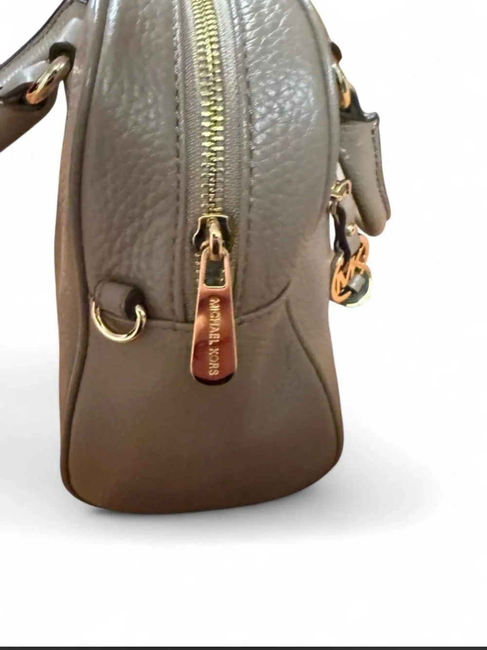 Michael Kors Knox Satchel featuring a prominent tassel and gold-tone hardware